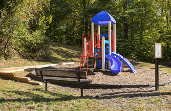 Childrens play ground with slides and bench
